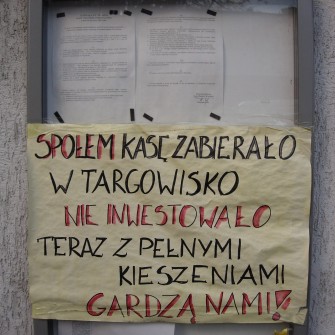 Targowisko powstało w 1947 roku po zamknięciu szaberplacu, który funkcjonował w tym samym miejscu. Z biegiem lat stało się jednym z najbardziej popularnych targów we Wrocławiu, przyciągającym wielu mieszkańców. W latach 90. XX wieku funkcjonowało pod rozłożonym namiotem cyrkowym „Goliat”. W 2006 roku zostało zamknięte, a na jego miejscu wybudowano Pasaż Grunwaldzki. Na fotografii plakat protestacyjny kierowany pod adresem właścicieli terentu - PSS Społem Północ.
